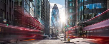 blurred double decker buses in downtown London