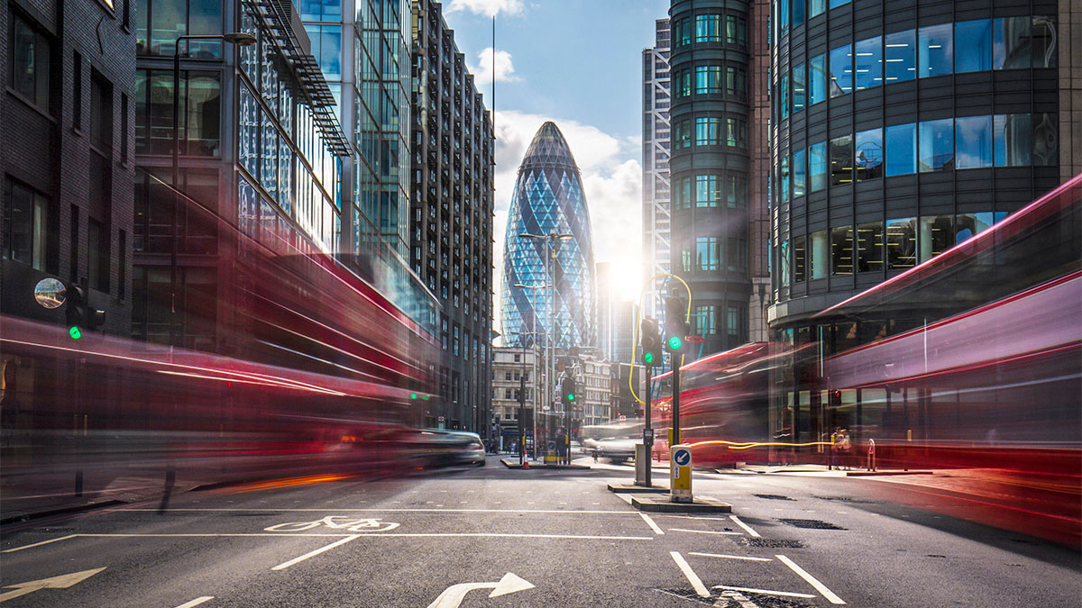 blurred double decker buses in downtown London