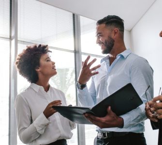 Three people in an office talking about Talent Attraction