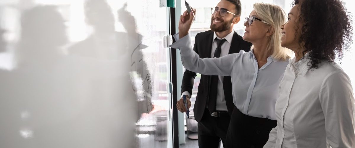 People drawing a map of ATS integrations on a whiteboard