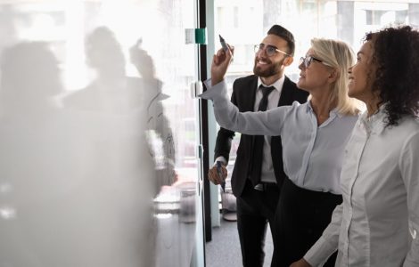 People drawing a map of ATS integrations on a whiteboard