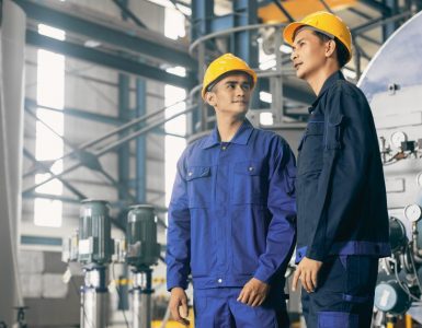 two men in a manufacturing facility