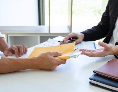 Person signing a contract and being given cash