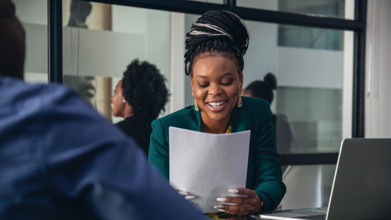 internal candidate being asked a question in a job interview looking at a piece of paper